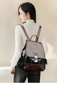 Detail of drawstring backpack with metal kangaroo logo and stylish two-tone cow leather texture