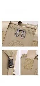 Detail view of khaki nylon backpack showing metal zippers, brand logo and reinforced stitching