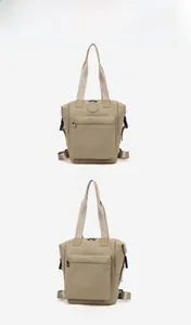 Detailed angle view of the khaki waterproof nylon backpack with circular logo and zipper pocket