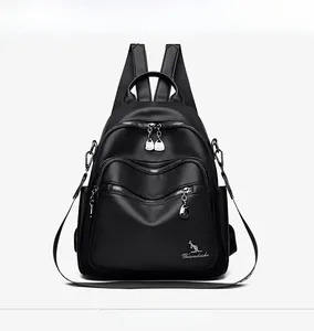 Close-up of black leather backpack with lychee texture and metallic zipper details