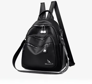 Close-up of black lychee leather texture and silver zipper details on a backpack