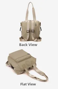 Detail view of khaki nylon backpack showing the back anti-theft pocket and flat lay design