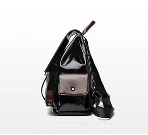 Side view of two-tone leather backpack with magnetic buckle pocket and adjustable strap