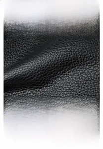 Close-up of black lychee grain leather featuring embossed kangaroo logo and detailed stitching