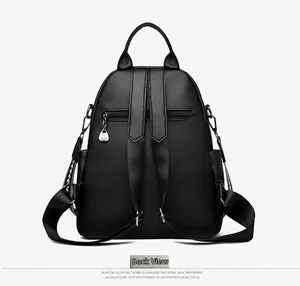Back view of black embroidered leather backpack with adjustable straps and zipper pocket