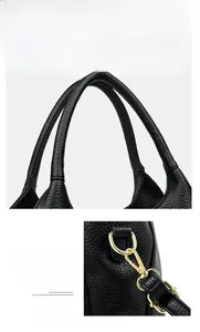 Detail of leather tote with reinforced handles and golden detachable shoulder strap hooks