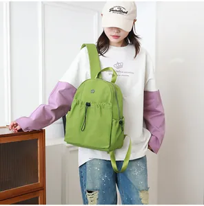 Waterbestendige groene nylon rugzak getoond op model met trekkoord detail