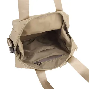 Spacious khaki nylon backpack interior showing multi-functional pockets and wide handle