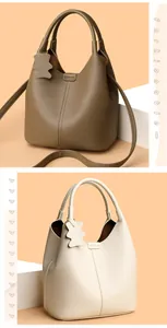 Detail of genuine leather bucket bags in khaki and beige with bear charm ornaments