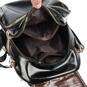 Premium black leather backpack featuring colorful striped straps and multi-compartment interior