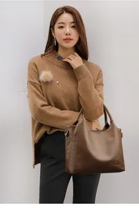 Close-up of deep coffee lychee pattern leather tote bag with fine embossed logo detail