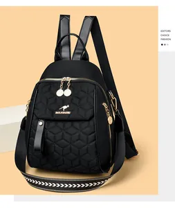 Detail of black quilted backpack with golden kangaroo logo and hexagonal stitching pattern