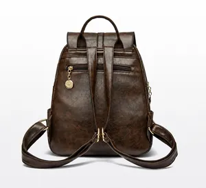 Vista trasera de la mochila vintage de cuero marrón con cremallera antirrobo y colgante oro