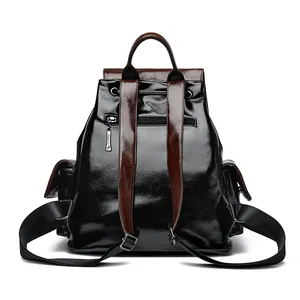 Black and brown leather backpack with drawstring closure and anti-theft back pocket