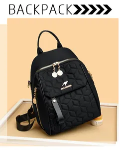 Detail of black quilted backpack with golden kangaroo logo and double metal zippers