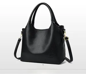 Detailed macro view of black lychee grain leather tote bag with embossed kangaroo logo