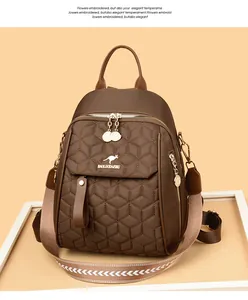 Detail of brown quilted backpack with kangaroo logo and woven geometric strap on tray