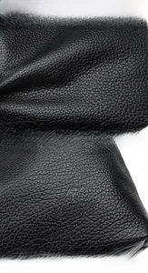 Detailed macro view of black lychee grain leather with the BAI LIDAISHU kangaroo logo