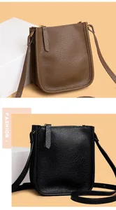 Detail of lychee textured leather mini crossbody bags in brown and black with gold zippers