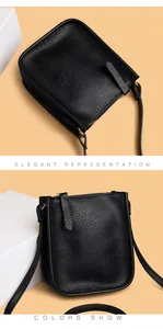 Detail of black genuine leather phone bag showing pebbled texture and gold zipper