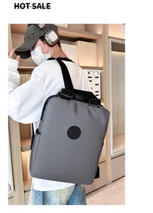 Grijze nylon rugzak met rond logo en verstelbare banden getoond op een fotomodel