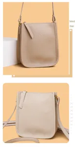 Detailed close-up of beige leather phone bag showing zipper and lychee grain texture
