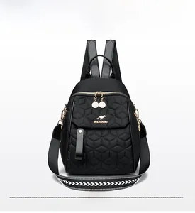 Front detail of black quilted backpack with golden kangaroo logo and hexagonal stitching