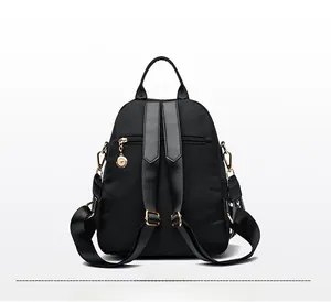 Back view of black quilted backpack with adjustable straps and anti-theft zipper pocket