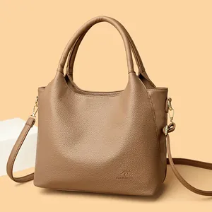 Brown lychee leather tote bag with double handles and adjustable shoulder strap