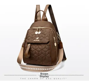 Detail of brown quilted backpack with honeycomb pattern and golden kangaroo logo