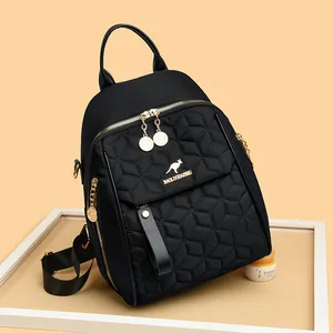 Chic black quilted backpack with golden kangaroo logo and hexagonal stitching pattern