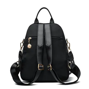 Black quilted kangaroo backpack with wide straps and anti-theft back pocket detail