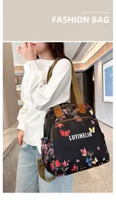 Detail of floral butterfly print on waterproof fabric backpack with sturdy woven straps