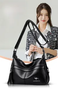 Close-up of black lychee grain leather shoulder bag with tassel and kangaroo logo detail