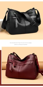 Detail of multi-pocket crossbody bag in textured black and deep red lychee leather