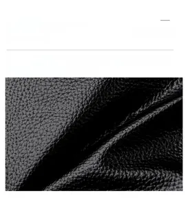 Close-up macro view of high-quality black lychee texture leather on a luxury crescent bag