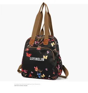 Close-up of waterproof floral backpack showing colorful butterfly print and zip pocket