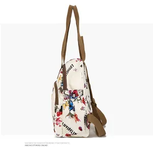 Side view of floral butterfly backpack showing wide woven straps and pocket details