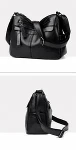 Detail view of premium black pebble grain leather handbag with silver-tone metal buckles