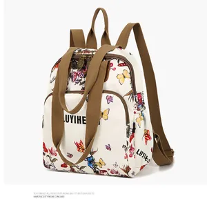 Detail view of floral butterfly print backpack with brown nylon straps and sturdy metal zippers