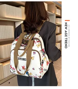 Close-up of the vintage floral backpack featuring butterfly prints and wide brown straps