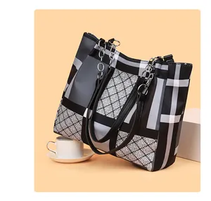 Close-up of geometric diamond quilted tote bag with silver sequin chain detail