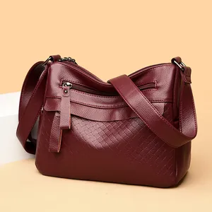 Quilted burgundy leather crossbody bag for women with multi-zipper and wide strap