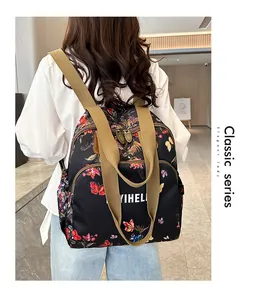 Detail of vintage floral backpack with butterfly prints and branded webbing straps