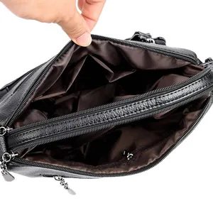 Black quilted leather shoulder bag with multiple compartments and silver metal zippers