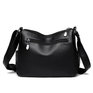 Classic black leather crossbody bag with multiple zippers and litchi texture finish