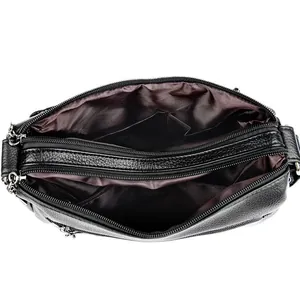 Classic black leather crossbody bag featuring a three-zipper multi-pocket storage design
