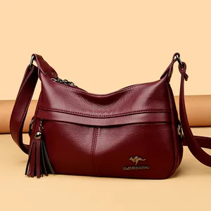 Elegant burgundy grain leather crescent bag with tassel and kangaroo logo for women