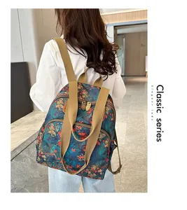 Detail of floral vintage backpack with khaki canvas straps and multi-zipper pockets