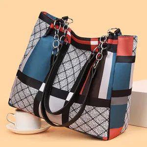 Chic multi-color geometric patchwork tote bag with chain handles and diamond pattern